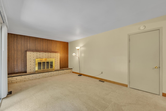 2145 Steeplechase Dr, Ann Arbor, MI 48103 - unfurnished living room featuring carpet floors, wood walls, and a fireplace