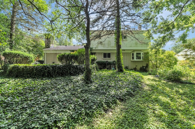 2145 Steeplechase Dr, Ann Arbor, MI 48103 - rear view of house with brick siding and a chimney