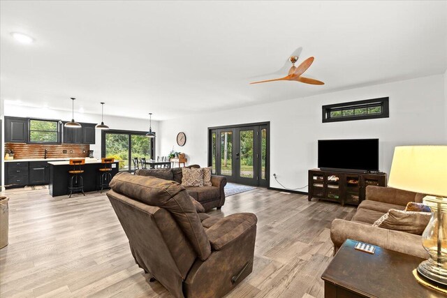 7499 Mathews Rd, Spring Arbor, MI 49283 - living room featuring a ceiling fan, light wood-type flooring, and french doors
