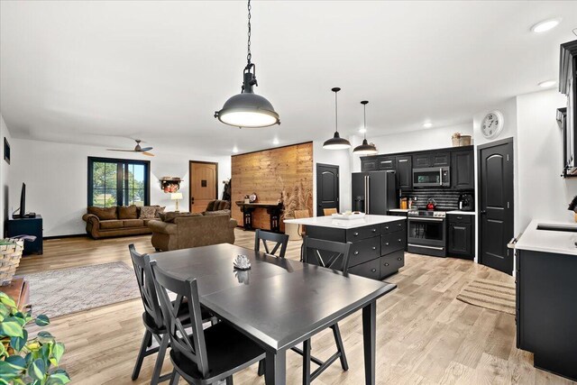 7499 Mathews Rd, Spring Arbor, MI 49283 - dining room with light wood-style flooring, ceiling fan, and recessed lighting