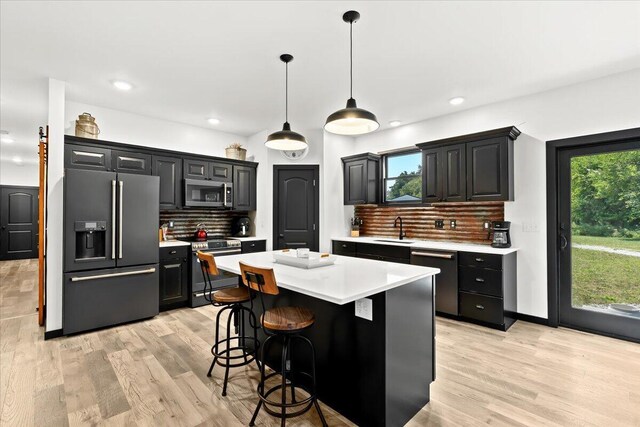 7499 Mathews Rd, Spring Arbor, MI 49283 - kitchen with appliances with stainless steel finishes, light countertops, dark cabinetry, and recessed lighting