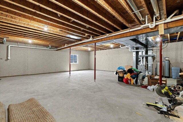 7499 Mathews Rd, Spring Arbor, MI 49283 - basement featuring a water softener system and heating unit