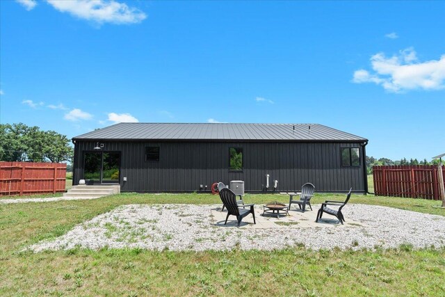 7499 Mathews Rd, Spring Arbor, MI 49283 - rear view of property featuring a fire pit and a metal roof