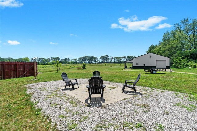 7499 Mathews Rd, Spring Arbor, MI 49283 - view of yard featuring a patio area, a detached garage, and an outdoor fire pit
