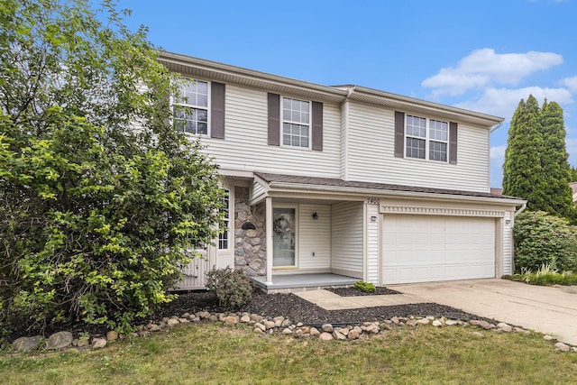 7400 Willow Creek Dr, Ypsilanti, MI 48197 - view of front of property with a garage, concrete driveway, a porch, and stone siding