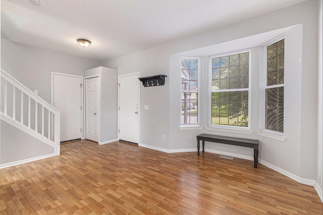 7400 Willow Creek Dr, Ypsilanti, MI 48197 - spare room featuring light wood-style flooring and stairway
