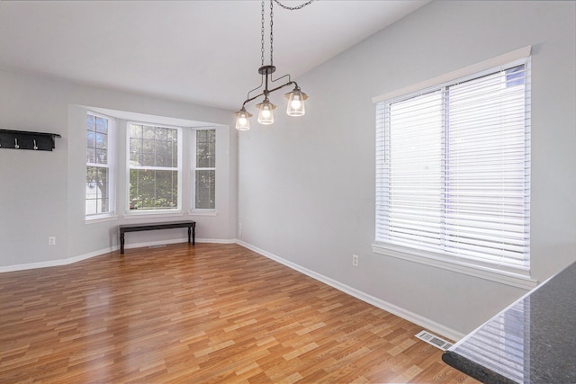 7400 Willow Creek Dr, Ypsilanti, MI 48197 - unfurnished dining area with light wood-style flooring and baseboards