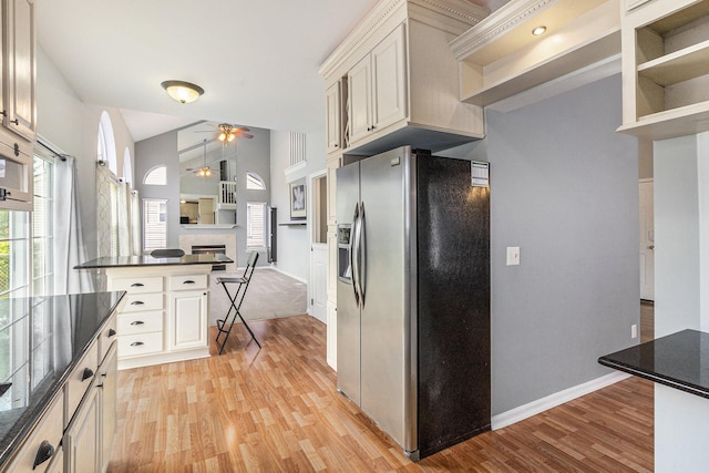 7400 Willow Creek Dr, Ypsilanti, MI 48197 - kitchen with stainless steel fridge with ice dispenser, light wood-style flooring, a ceiling fan, open floor plan, and a breakfast bar