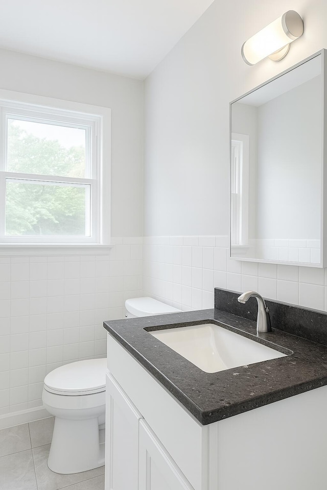 111 Butternut St, Three Oaks, MI 49128 - half bathroom with vanity, tile walls, and tile patterned floors