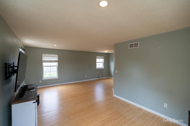 622 Cedar Square St, Holland, MI 49423 - unfurnished living room with baseboards and light wood finished floors