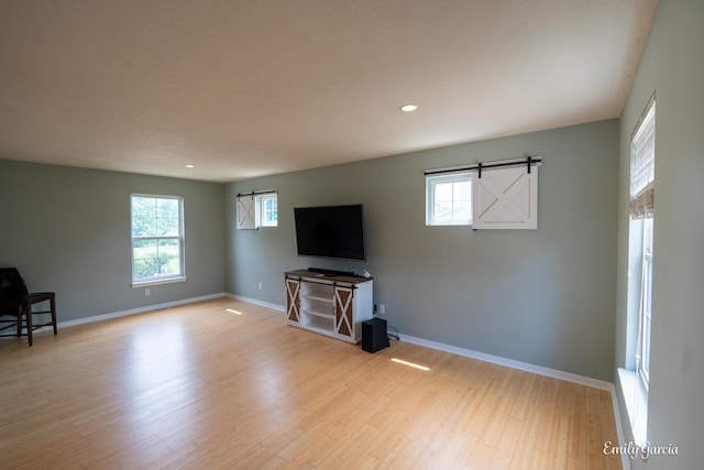 622 Cedar Square St, Holland, MI 49423 - unfurnished living room with light wood-type flooring and recessed lighting