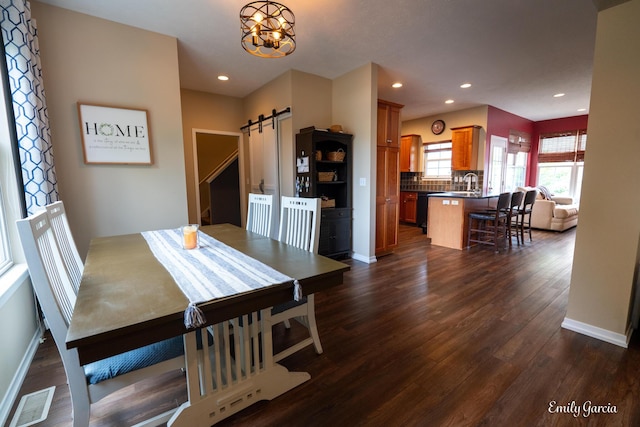 622 Cedar Square St, Holland, MI 49423 - dining room with a barn door, dark wood-style flooring, recessed lighting, and a chandelier