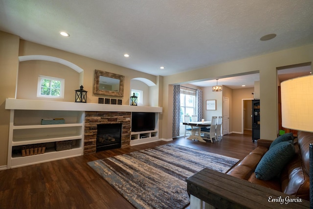 622 Cedar Square St, Holland, MI 49423 - living area with wood finished floors, healthy amount of natural light, a fireplace, recessed lighting, and a textured ceiling