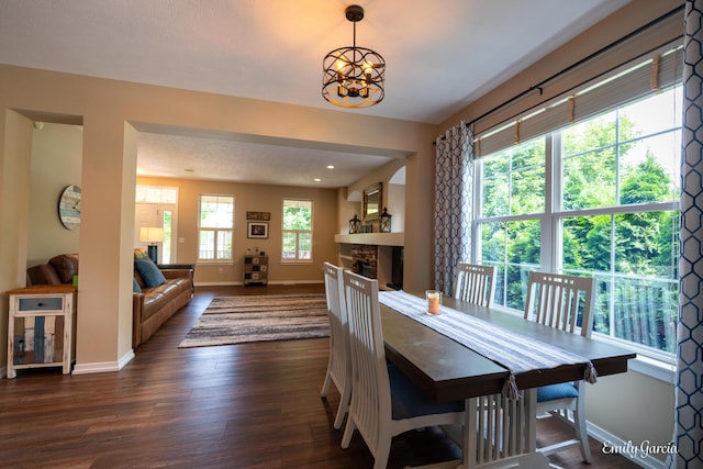 622 Cedar Square St, Holland, MI 49423 - dining space with a stone fireplace, dark wood-type flooring, and a chandelier