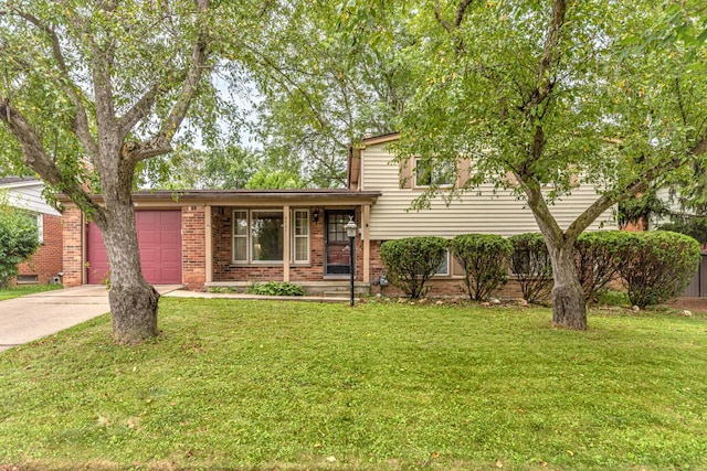 2707 Brandywine Dr, Ann Arbor, MI 48104 - tri-level home with concrete driveway, an attached garage, a front yard, and brick siding