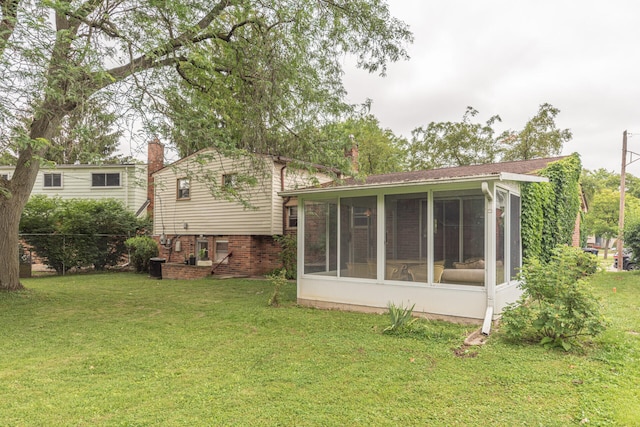2707 Brandywine Dr, Ann Arbor, MI 48104 - rear view of house with a sunroom and a yard