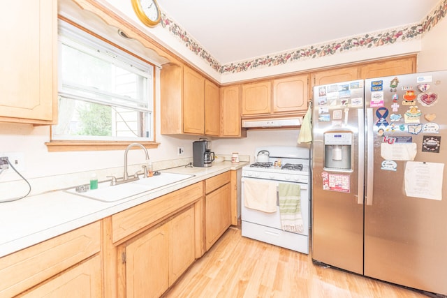 2707 Brandywine Dr, Ann Arbor, MI 48104 - kitchen featuring white range with gas cooktop, stainless steel fridge with ice dispenser, under cabinet range hood, light brown cabinets, and light countertops