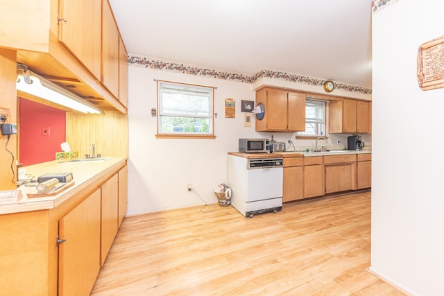 2707 Brandywine Dr, Ann Arbor, MI 48104 - kitchen with white dishwasher, stainless steel microwave, light countertops, and light wood-style floors