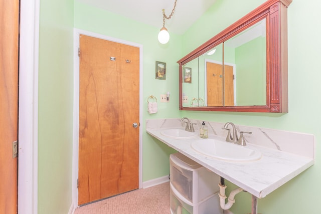 2707 Brandywine Dr, Ann Arbor, MI 48104 - bathroom featuring baseboards and double vanity