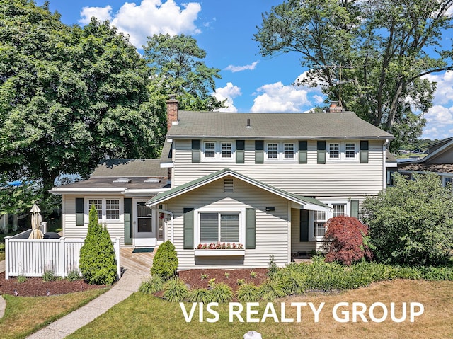 537 Buena Vista Dr, Spring Lake, MI 49456 - view of front of property featuring a chimney and a front lawn