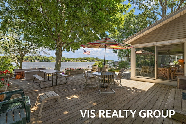 537 Buena Vista Dr, Spring Lake, MI 49456 - wooden deck with a hot tub, a water view, outdoor dining area, and a sunroom