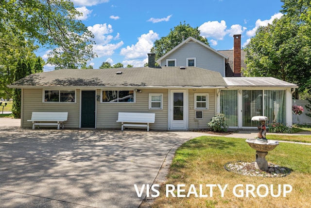 537 Buena Vista Dr, Spring Lake, MI 49456 - view of front of property featuring a chimney and a sunroom