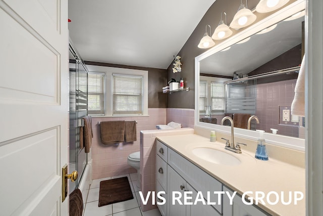 537 Buena Vista Dr, Spring Lake, MI 49456 - bathroom featuring tile walls, tile patterned floors, healthy amount of natural light, vanity, and bath / shower combo with glass door