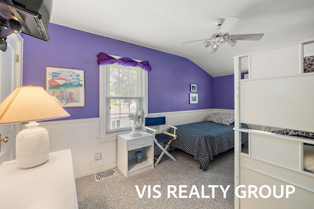 537 Buena Vista Dr, Spring Lake, MI 49456 - carpeted bedroom featuring wainscoting, vaulted ceiling, and ceiling fan