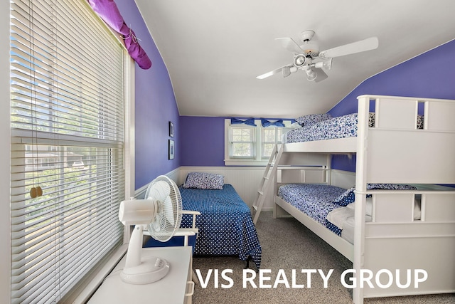537 Buena Vista Dr, Spring Lake, MI 49456 - carpeted bedroom featuring vaulted ceiling, wainscoting, and a ceiling fan