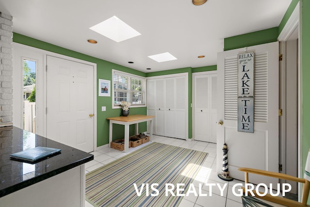 537 Buena Vista Dr, Spring Lake, MI 49456 - entrance foyer featuring healthy amount of natural light, a skylight, light tile patterned flooring, and recessed lighting