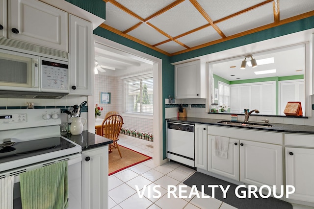 537 Buena Vista Dr, Spring Lake, MI 49456 - kitchen with white appliances, light tile patterned floors, white cabinetry, backsplash, and ceiling fan