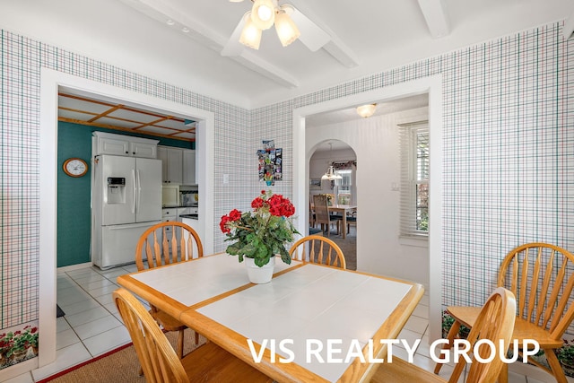 537 Buena Vista Dr, Spring Lake, MI 49456 - dining room with arched walkways, light tile patterned floors, ceiling fan, and wallpapered walls