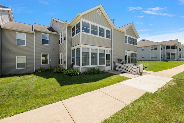 1734 Weatherstone Dr, Ann Arbor, MI 48108 - rear view of property featuring a lawn