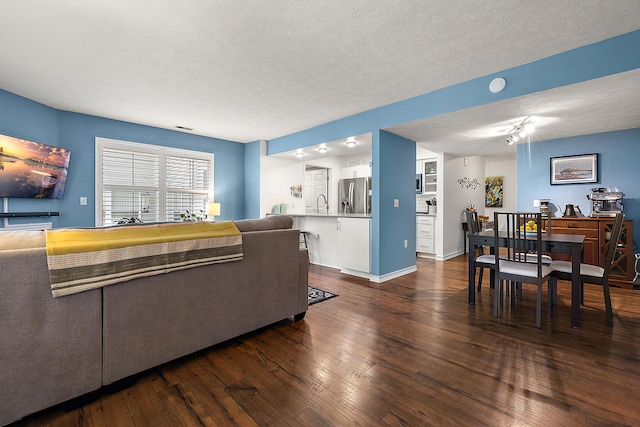 1734 Weatherstone Dr, Ann Arbor, MI 48108 - living area featuring dark wood-style flooring and a textured ceiling
