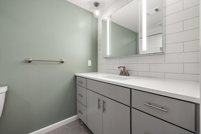 1734 Weatherstone Dr, Ann Arbor, MI 48108 - bathroom with vanity, tasteful backsplash, and tile patterned floors