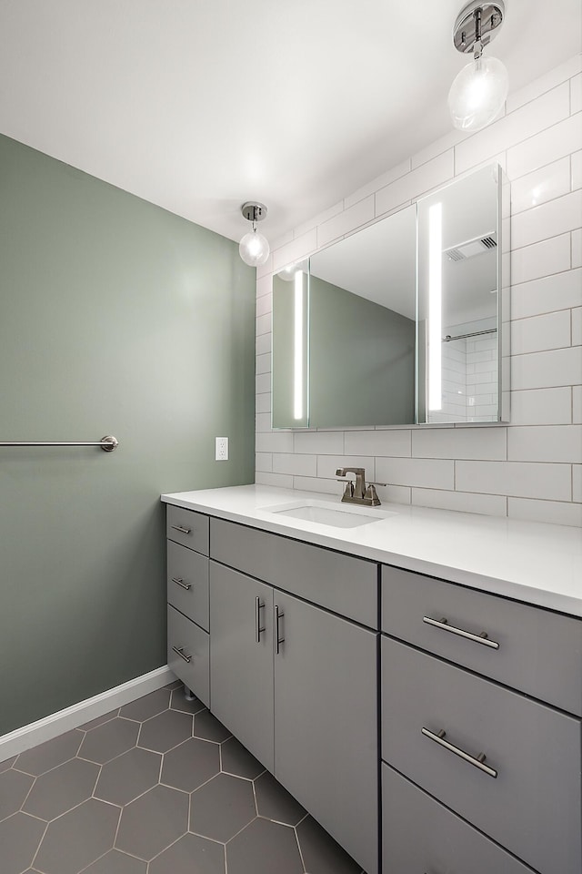 1734 Weatherstone Dr, Ann Arbor, MI 48108 - bathroom with vanity, tasteful backsplash, and tile patterned floors