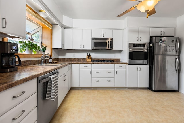 1534 Barrington Pl, Ann Arbor, MI 48103 - kitchen featuring appliances with stainless steel finishes, dark countertops, white cabinetry, and ceiling fan
