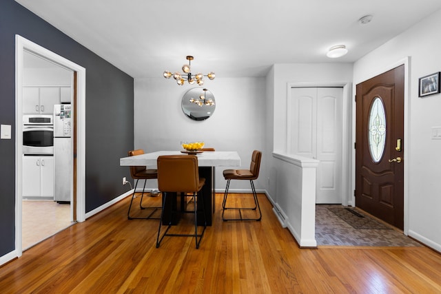 1534 Barrington Pl, Ann Arbor, MI 48103 - dining space featuring a chandelier and wood finished floors