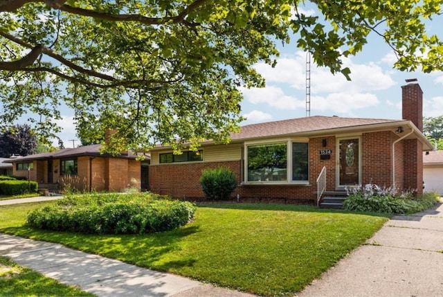 1534 Barrington Pl, Ann Arbor, MI 48103 - single story home with a chimney, brick siding, and a front yard