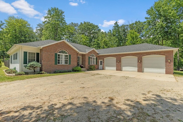 23103 13 Mile Rd, Big Rapids, MI 49307 - ranch-style home with a garage, concrete driveway, brick siding, and roof with shingles