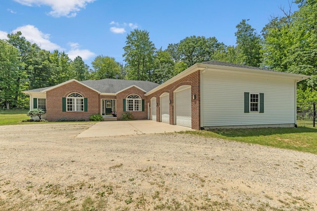 23103 13 Mile Rd, Big Rapids, MI 49307 - ranch-style house featuring an attached garage, concrete driveway, and brick siding