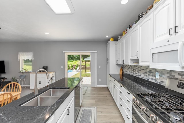 23103 13 Mile Rd, Big Rapids, MI 49307 - kitchen with stainless steel appliances, backsplash, recessed lighting, white cabinetry, and light wood finished floors