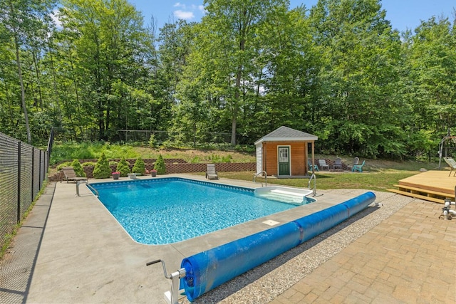 23103 13 Mile Rd, Big Rapids, MI 49307 - view of swimming pool with a deck, an outbuilding, a patio, and view of scattered trees