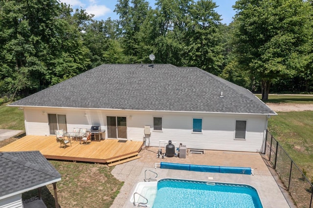 23103 13 Mile Rd, Big Rapids, MI 49307 - back of house with a wooden deck, a covered pool, and a shingled roof