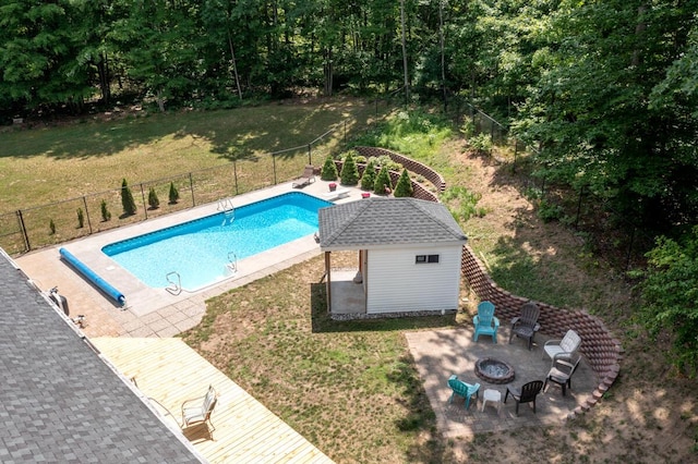 23103 13 Mile Rd, Big Rapids, MI 49307 - view of swimming pool featuring an outdoor fire pit, a patio, and an outbuilding