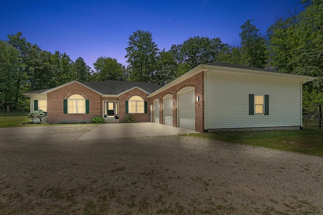 23103 13 Mile Rd, Big Rapids, MI 49307 - ranch-style house featuring a garage, concrete driveway, and brick siding