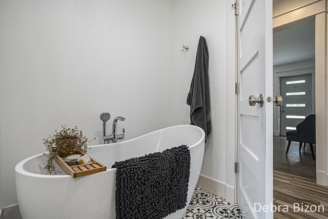 17929 S River Rd, Three Rivers, MI 49093 - bathroom featuring a freestanding bath and wood finished floors