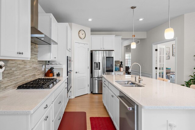 4814 Cranston Rd Unit 86, Canton, MI 48188 - kitchen featuring wall chimney exhaust hood, appliances with stainless steel finishes, backsplash, white cabinets, and light wood finished floors