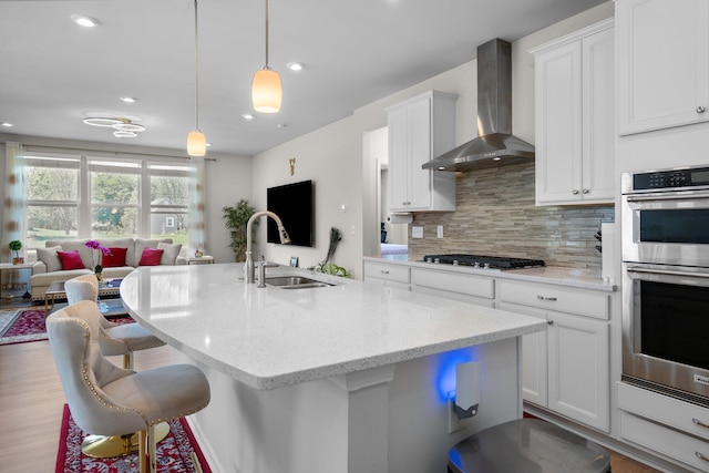4814 Cranston Rd Unit 86, Canton, MI 48188 - kitchen with wall chimney exhaust hood, stainless steel appliances, open floor plan, tasteful backsplash, and white cabinets