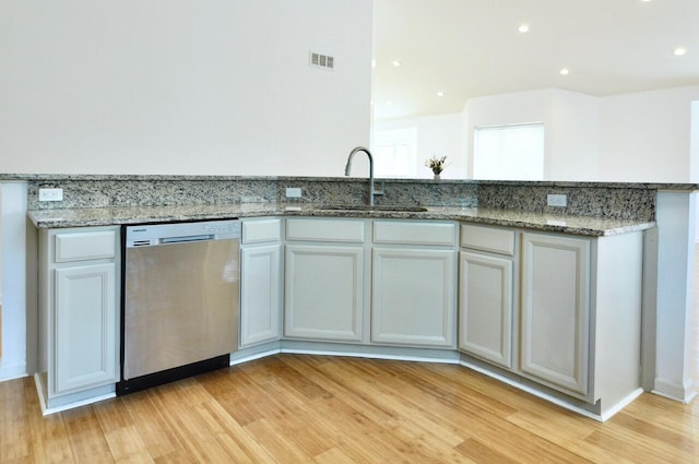 2019 Chalmers Dr, Ann Arbor, MI 48104 - kitchen with stainless steel dishwasher, light wood finished floors, light stone counters, and recessed lighting
